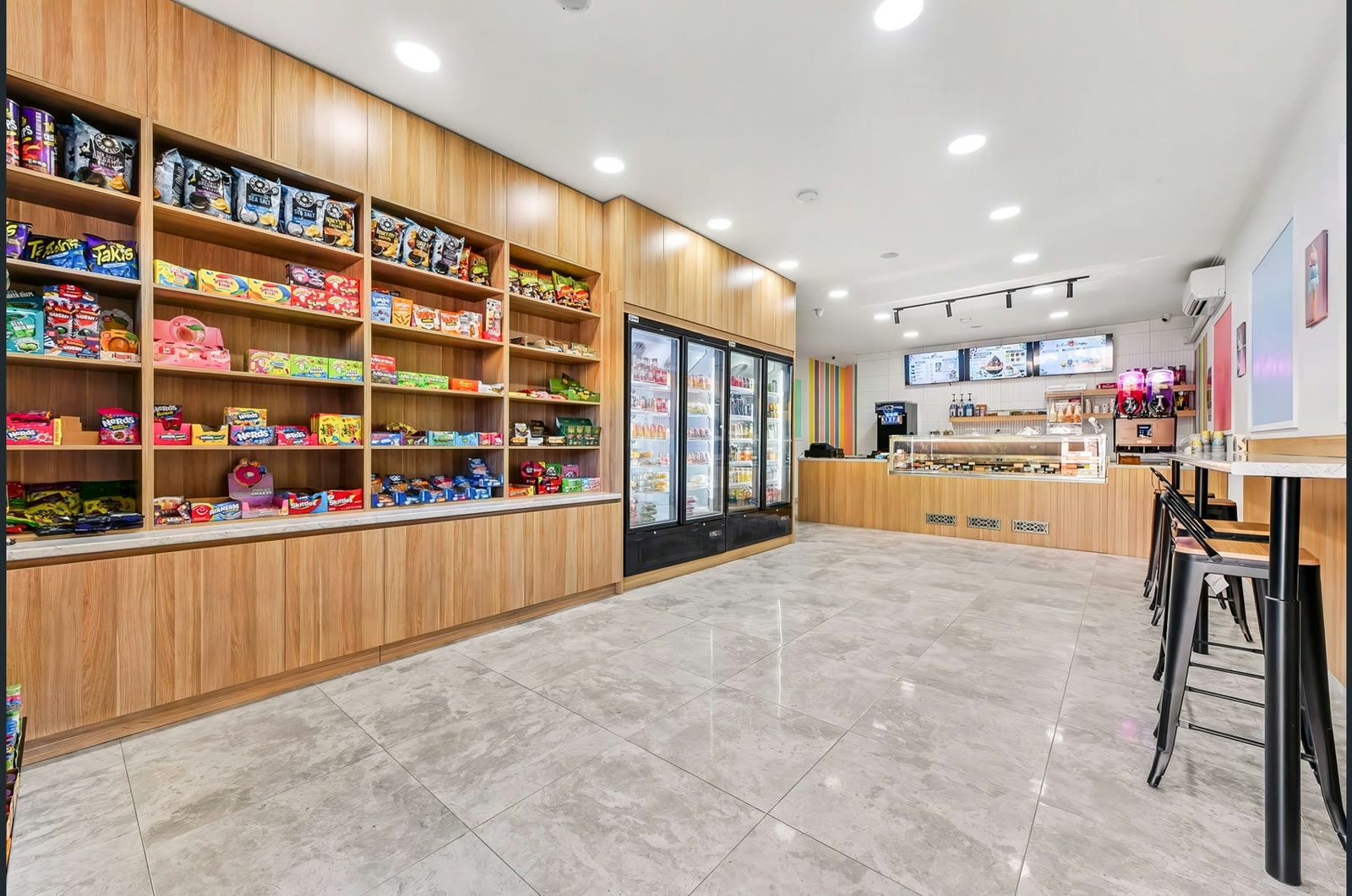 Candy Cream’s bright interior with a candy wall, drinks fridges and ice cream counter